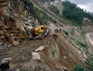 A bulldozer clears a landslide on the Tezpur to Tawang highway, which runs to the Chinese-occupied Tibetan border in Arunachal Pradesh Photo: Reuters