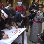 Student protestors writing the name “Lobsang Konchok”in their own blood