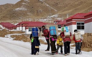 Tibetan nomad girls carry water to their new homes in a resettlement village. Photo: Sanghee Liu/smh.com.au