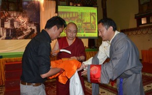 Ngawang Rabgyal, Director of Lha Charitable Trust, presents the Felicitation Volume Photo: samdhongrinpoche.com